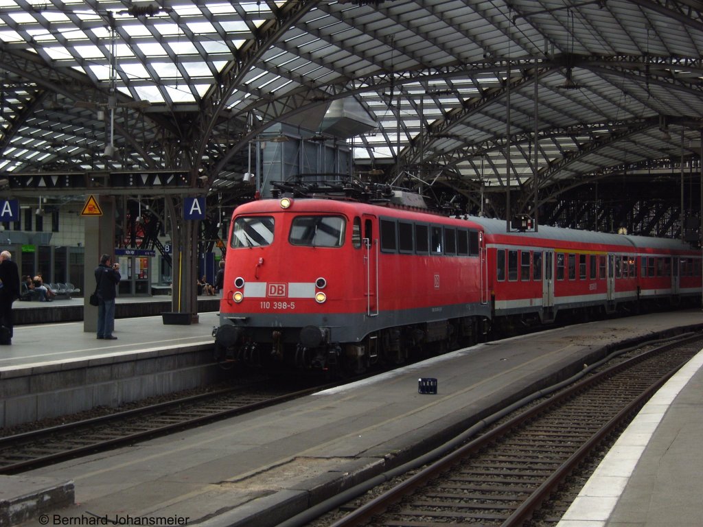 Mit eingeschaltetem Spitzenlicht zieht 110 398-5 den RE 9 Verstrkerzug nach Siegen aus dem Klner Hbf. Juli 2009