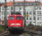 110 447-0 bei der Einfahrt in Hannover; vor der Kulisse des dicht bebauten Bahnhofsviertels.