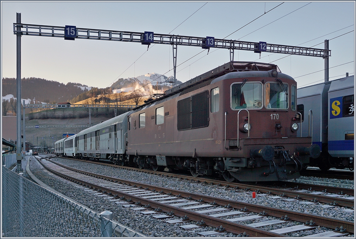 Auf den ersten Blick nichts besonderes, doch der zweite genauere offenbart spannendes: Nach der Lok, der BLS Re 4/4 170 (UIC 91 85 4425 170-8)  Brig Glis  steht ein interessanter Zug: Zwischen den Dmz 090 (UIC D-RADBE 75 80 90 94 008-4 vorne und D-RADVE 75 80 90 94 007-6 ist ein Spurwechselbarer MOB Wagen gekuppelt!

12. Jan. 2020
