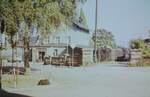Blick auf das Bahnhofsgeb�ude Eibenstock ob Bf mit 94 2105 am 16.9.1975